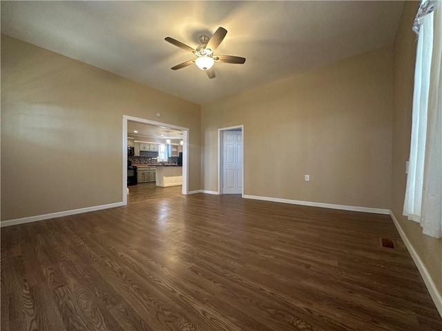 unfurnished room with dark wood finished floors, visible vents, baseboards, and ceiling fan