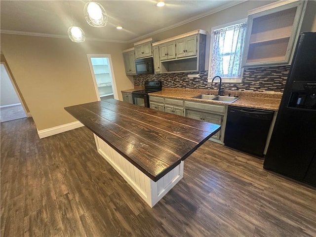 kitchen with a sink, ornamental molding, decorative backsplash, black appliances, and dark wood-style flooring