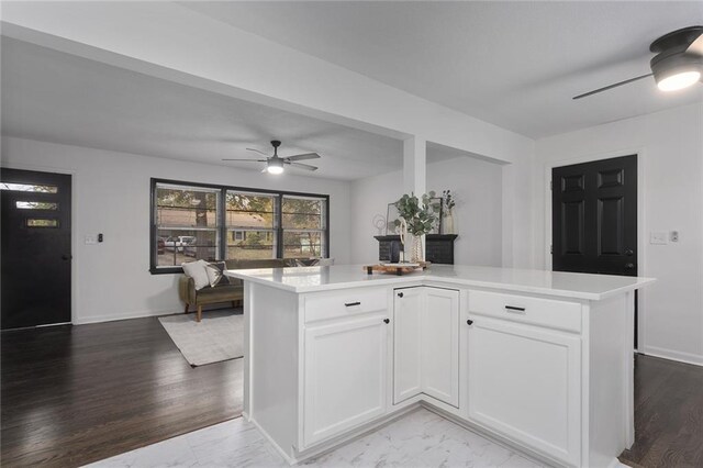 kitchen featuring white cabinets, ceiling fan, light countertops, and light wood-style flooring