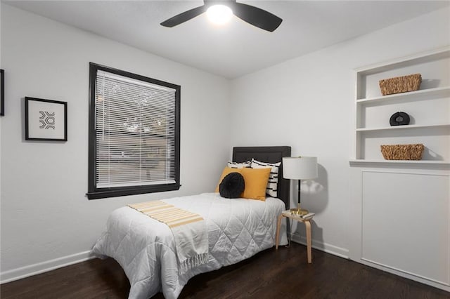 bedroom with a ceiling fan, baseboards, and wood finished floors