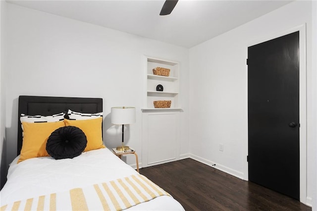 bedroom featuring ceiling fan, baseboards, and wood finished floors