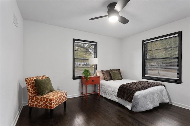 bedroom featuring visible vents, ceiling fan, baseboards, and wood finished floors