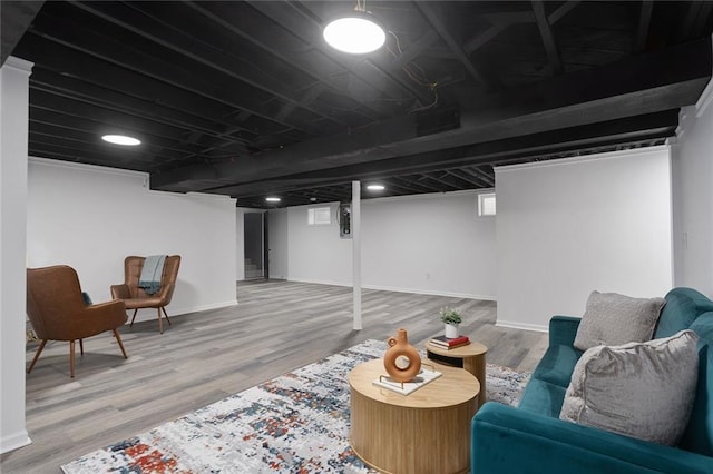 finished basement with baseboards and wood finished floors