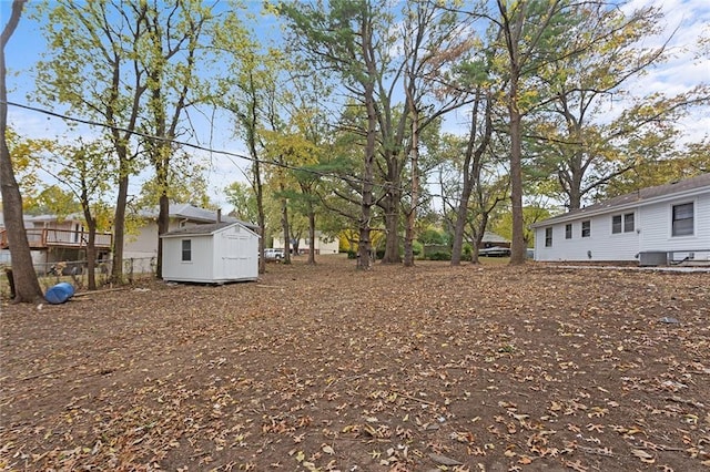 view of yard featuring a shed and an outdoor structure