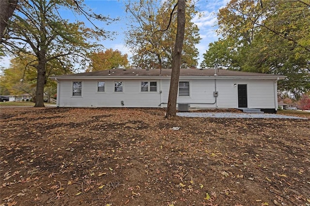 back of house with entry steps and central air condition unit