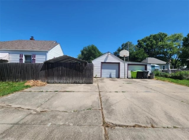 exterior space with a garage, fence, and an outdoor structure