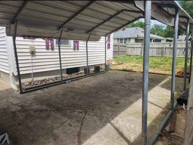 view of parking featuring a carport and fence