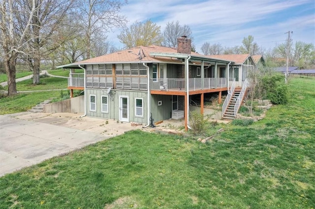 24722 Tonganoxie Dr, Leavenworth, KS 66048 - rear view of property featuring a deck, a patio, a chimney, stairs, and a yard