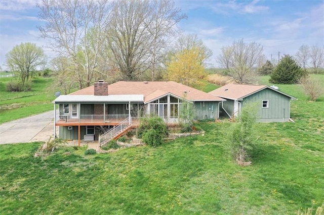 24722 Tonganoxie Dr, Leavenworth, KS 66048 - rear view of house with a sunroom, stairway, a yard, and a chimney