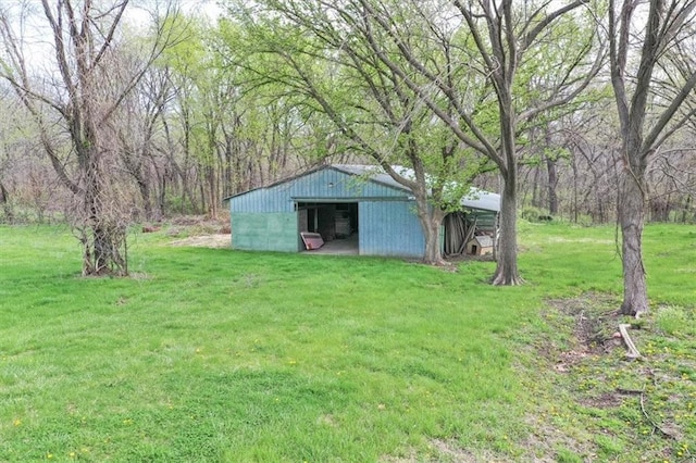 24722 Tonganoxie Dr, Leavenworth, KS 66048 - view of yard featuring a view of trees, a pole building, and an outdoor structure