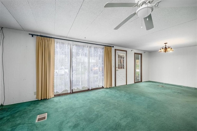 24722 Tonganoxie Dr, Leavenworth, KS 66048 - carpeted spare room featuring wooden walls, a ceiling fan, and visible vents