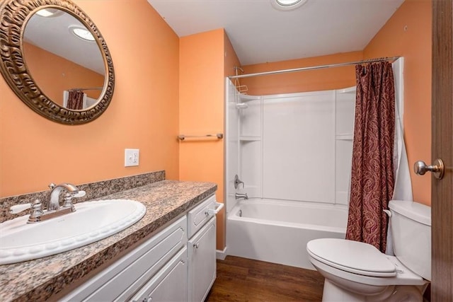 24722 Tonganoxie Dr, Leavenworth, KS 66048 - bathroom with vanity, toilet, wood finished floors, and shower / bath combo with shower curtain
