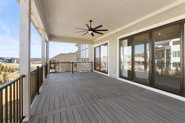 wooden deck with a ceiling fan