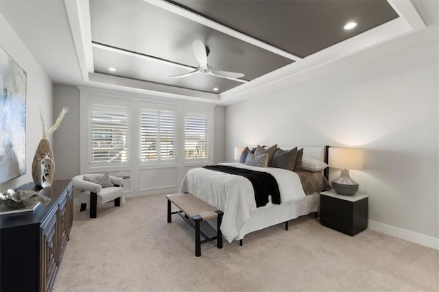 bedroom featuring a tray ceiling, recessed lighting, light carpet, ceiling fan, and baseboards