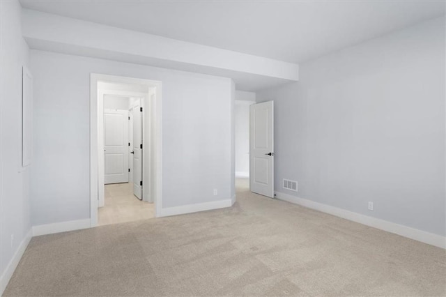 unfurnished bedroom with carpet floors, visible vents, and baseboards