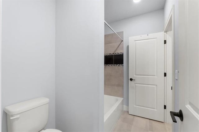 bathroom with tub / shower combination, toilet, and tile patterned floors