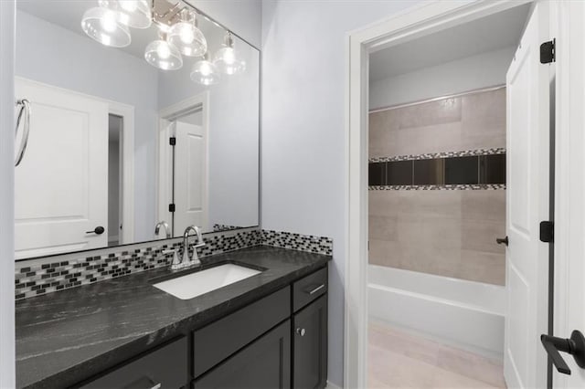 bathroom with tasteful backsplash and vanity