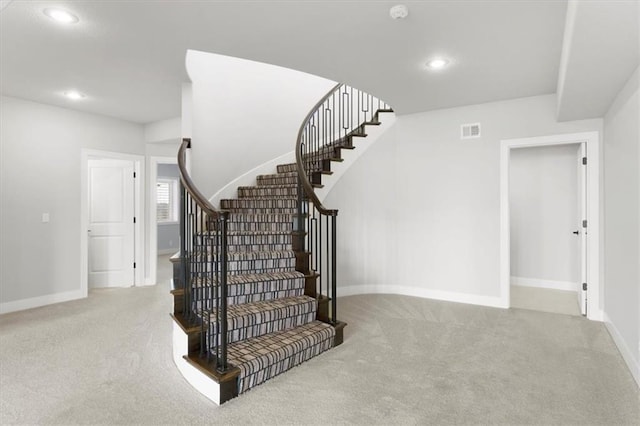 stairs featuring baseboards, visible vents, carpet flooring, and recessed lighting