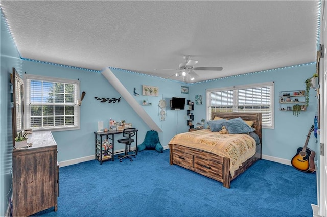 bedroom with a textured ceiling, multiple windows, and carpet