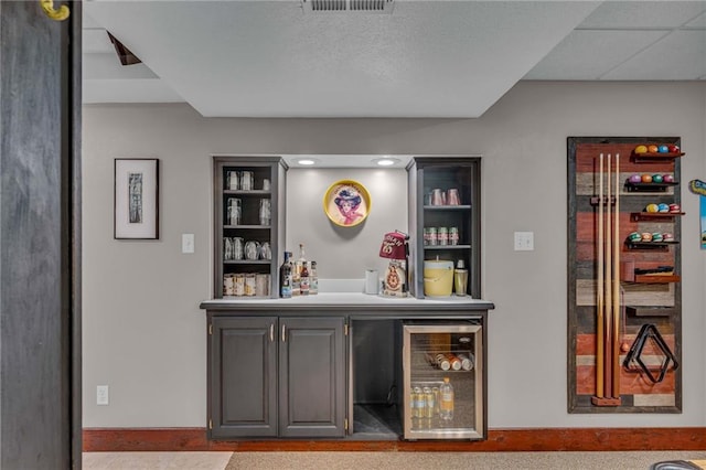 bar with a dry bar, beverage cooler, and visible vents