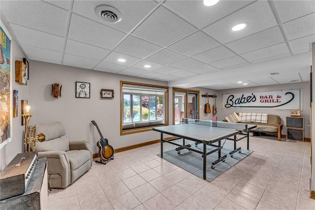 game room with light tile patterned floors, visible vents, and a drop ceiling