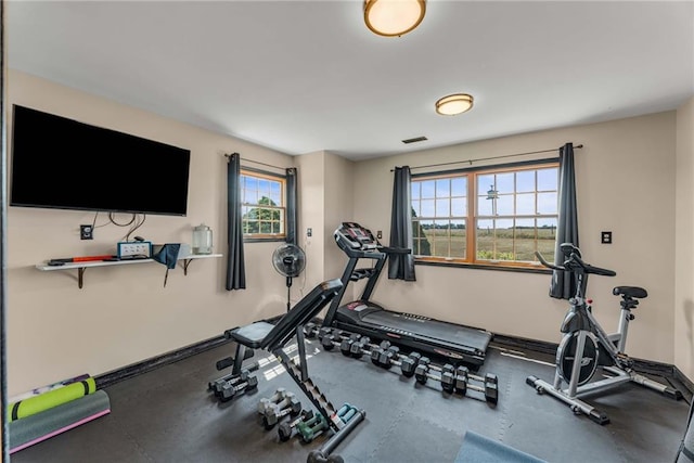 exercise room with visible vents and baseboards