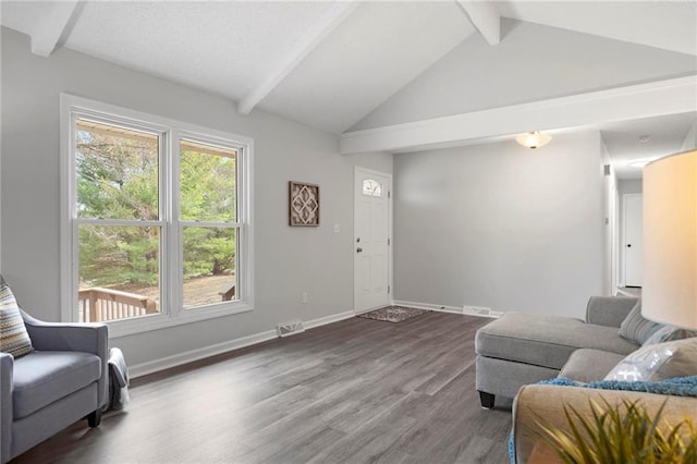 living room with lofted ceiling with beams, visible vents, baseboards, and wood finished floors