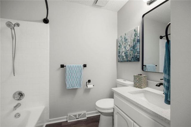 bathroom featuring visible vents, toilet, a textured ceiling, shower / bath combination, and baseboards