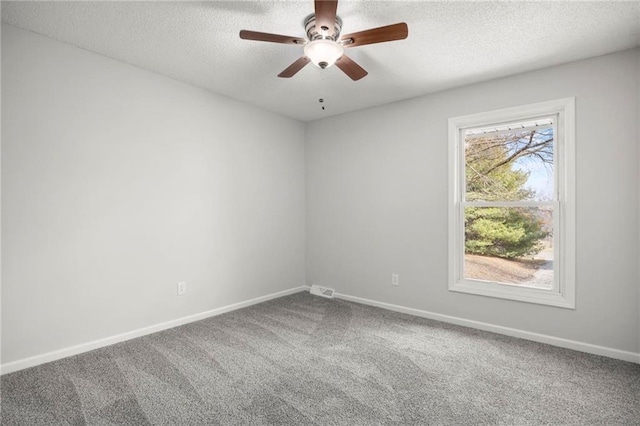 carpeted empty room with baseboards, a textured ceiling, and ceiling fan