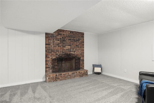 unfurnished living room with carpet flooring, a brick fireplace, and a textured ceiling