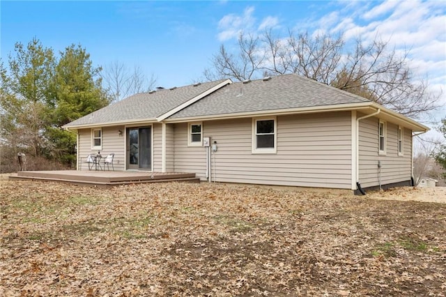 back of house featuring a deck and a shingled roof