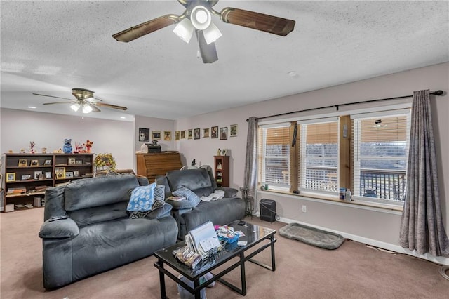 carpeted living room with baseboards, a ceiling fan, and a textured ceiling