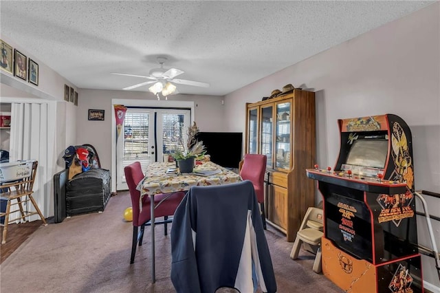 dining space featuring a textured ceiling, a ceiling fan, and carpet flooring