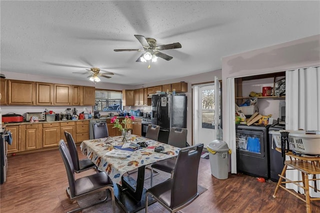 dining space featuring a textured ceiling, dark wood finished floors, a ceiling fan, and washer and dryer