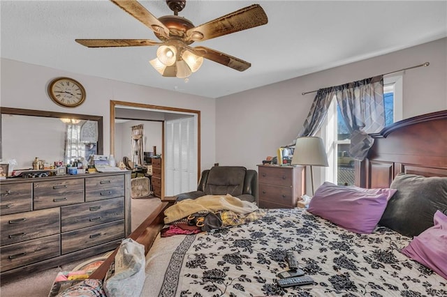 bedroom with ceiling fan and a closet