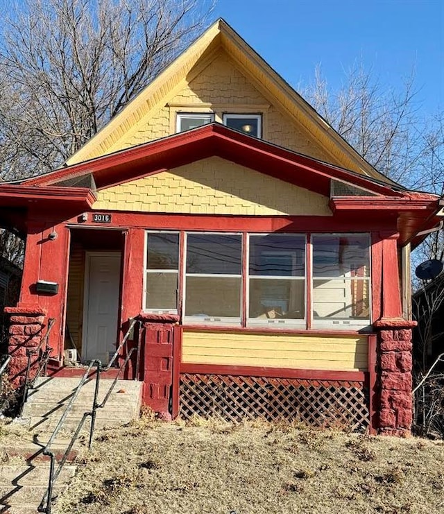 rear view of property with a sunroom