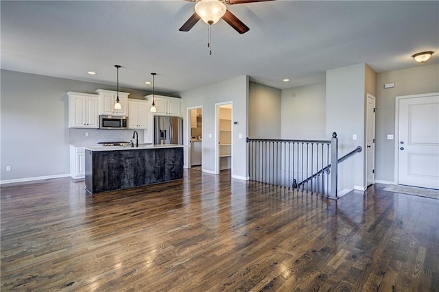 unfurnished living room featuring recessed lighting, dark wood-style floors, baseboards, and ceiling fan