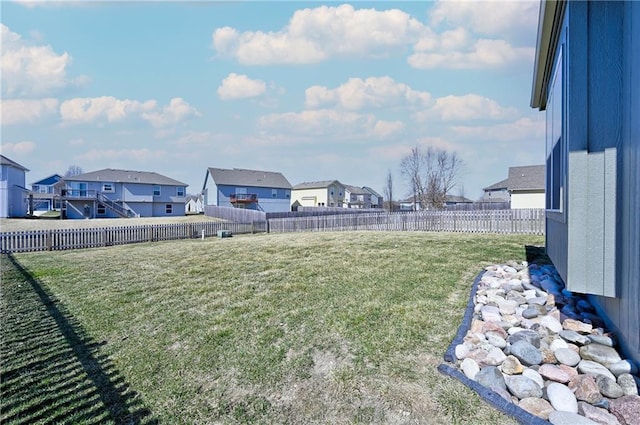 view of yard with a residential view and a fenced backyard