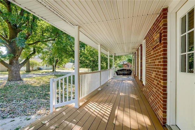 wooden terrace featuring covered porch