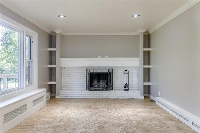 unfurnished living room with radiator, built in shelves, plenty of natural light, and crown molding