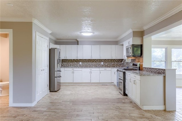 kitchen featuring white cabinets, light wood-style flooring, ornamental molding, stainless steel appliances, and stone counters