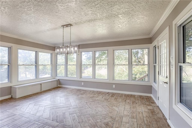 unfurnished sunroom featuring a chandelier and plenty of natural light