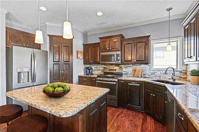 kitchen featuring light stone counters, backsplash, appliances with stainless steel finishes, a sink, and dark brown cabinetry