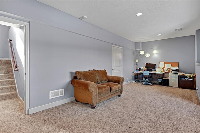 carpeted office space with recessed lighting, visible vents, a textured ceiling, and baseboards