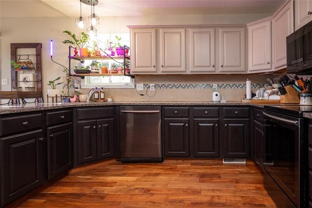 kitchen featuring light stone counters, light wood-type flooring, white cabinetry, and black appliances