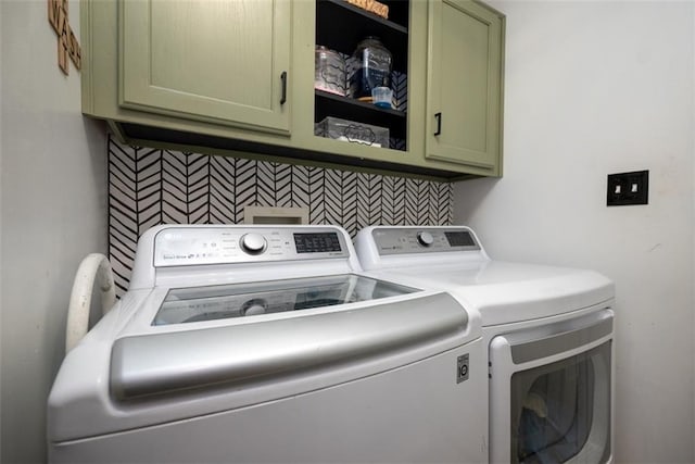 laundry room featuring washer and clothes dryer and cabinet space