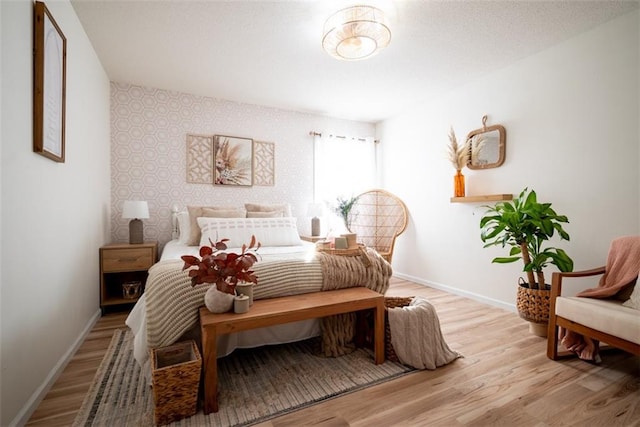 bedroom featuring baseboards and light wood-style floors