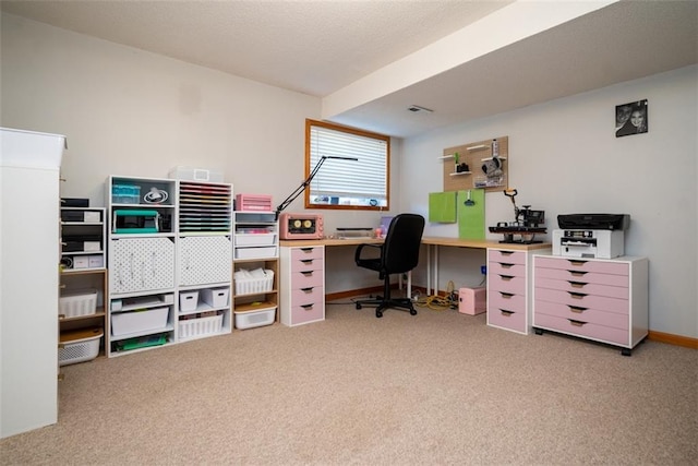 carpeted home office with baseboards