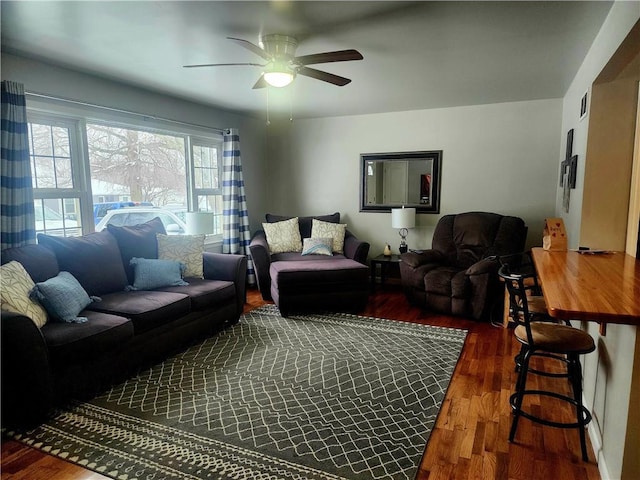 living area with ceiling fan and wood finished floors