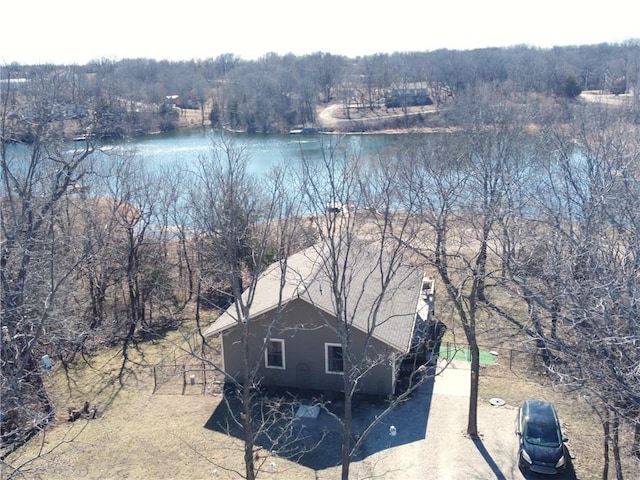 aerial view featuring a forest view and a water view